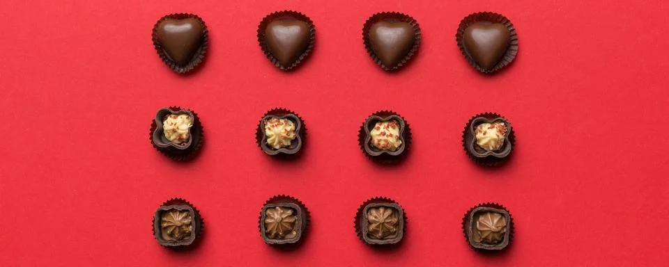 Different kinds of chocolates on colored table close-up. Top View and Flat La Stock Photos