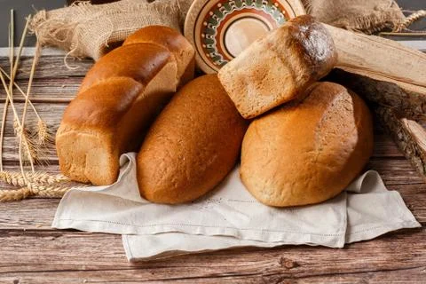 Different kinds of fresh bread as background, top view. Bakery gold rustic cr Stock Photos