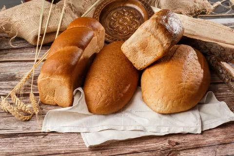 Different kinds of fresh bread as background, top view. Bakery gold rustic cr Stock Photos