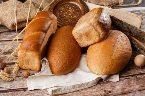 Different kinds of fresh bread as background, top view. Bakery gold rustic cr Stock Photos