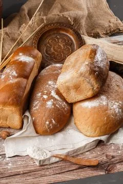 Different kinds of fresh bread as background, top view. Bakery gold rustic cr Stock Photos