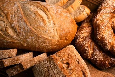 Different kinds of fresh bread as background Stock Photos