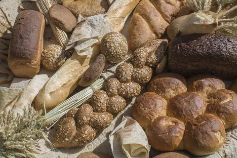 Different kinds of fresh bread as background, top view Foto stock