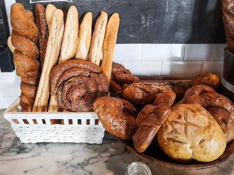 Different kinds of fresh bread displayed on a table Stock Photos