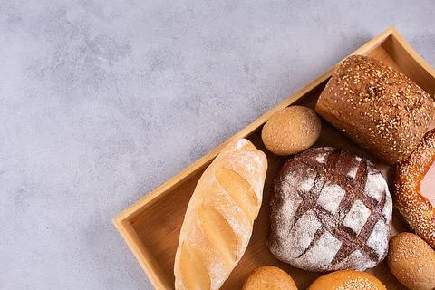 Different kinds of fresh bread on a tray. Stock Photos