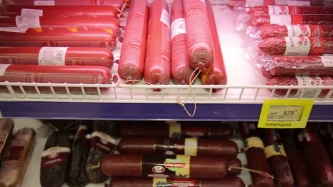 Different kinds of meat products and sausages on the display in the grocery Stock Footage 75488469