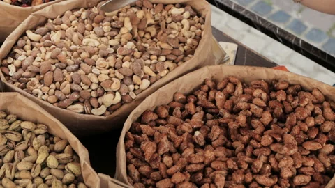 Different kinds of nuts in craft paper bags Stock Footage 94365912