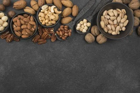 Different kinds nuts dark copy space background Resolution and high quality Stock Photos