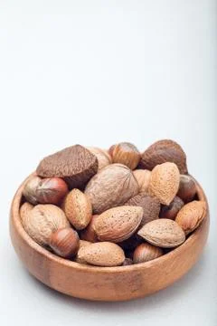Different kinds of nuts in the shell. Hazelnut, walnut, almond and brazil nut Stock Photos