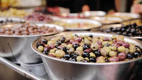 Different kinds of olives are sell on the bazaar. Olives stall in the Tel Aviv Stock Footage 273915933