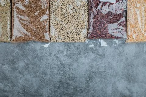 Different kinds of raw beans on a gray background Stock Photos