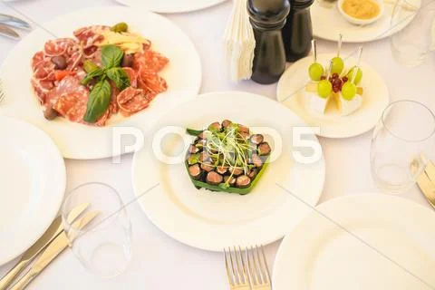 Different kinds of snacks, appetizers and salads on table waiting for guests Stock Photos