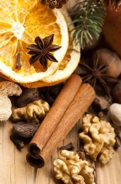 Different kinds of spices, nuts and dried oranges - christmas decoration Stock Photos