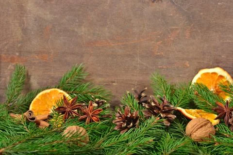 Different kinds of spices, nuts, dried oranges, cones and spruse branch Stock Photos