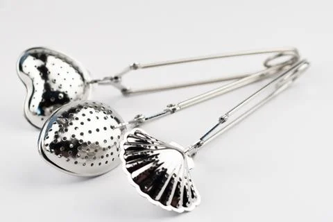 Different kinds of stainless tea strainers isolated on white background Stock Photos