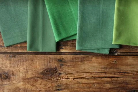 Different kitchen napkins on wooden table, flat lay. Space for text Stock Photos