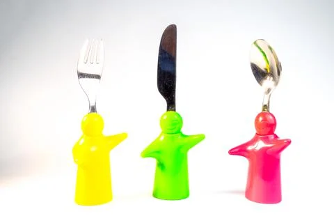 Different kitchen utensils. Kitchen utensils in cup on table against wall. A  Stock Photos