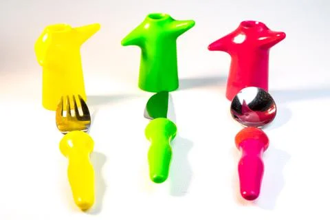 Different kitchen utensils. Kitchen utensils in cup on table against wall. A  Stock Photos
