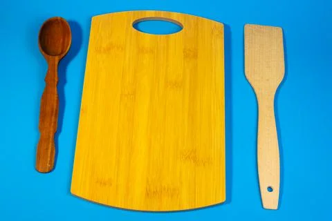 Different kitchen utensils. Kitchen utensils in cup on table against wall. A  Stock Photos