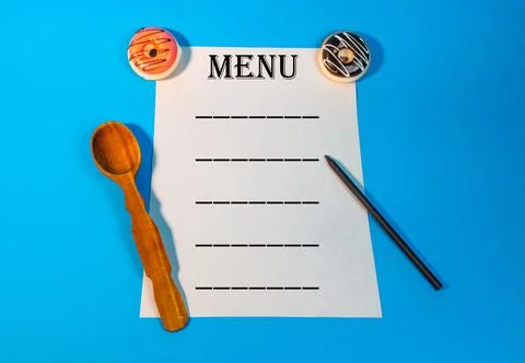 Different kitchen utensils. Kitchen utensils in cup on table against wall. A  Stock Photos