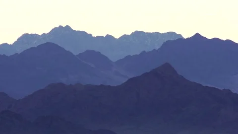 Different layers of mountain ranges in a soft lighting background at dusk Stock Footage 79786722