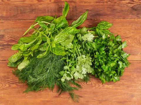 Different leafy greens on an old rustic table, top view Stock Photos