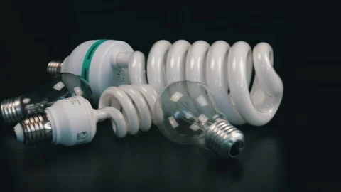Different light bulbs on the black table. Camera moves from right to left Stock Footage 105745255