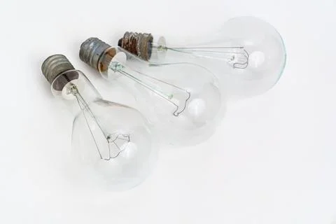 Different light bulbs placed on a white surface in a simple arrangement Stock Photos