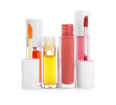 Different lip glosses and applicators isolated on white Stock Photos