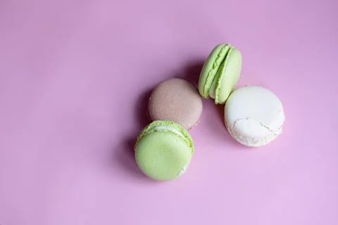 Different macaroons on a pink background, copy space Stock Photos
