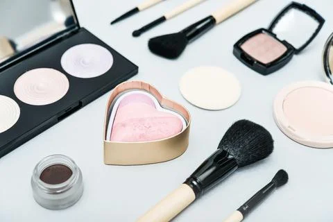 Different makeup brushes and cosmetics Stock Photos