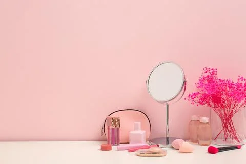 Different makeup products with mirror and gypsophila flowers on white table a Stock Photos