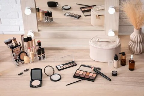 Different makeup products on table in room Stock Photos