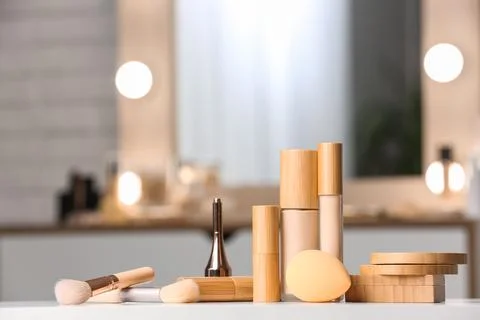 Different makeup products on white table against blurred background Stock Photos