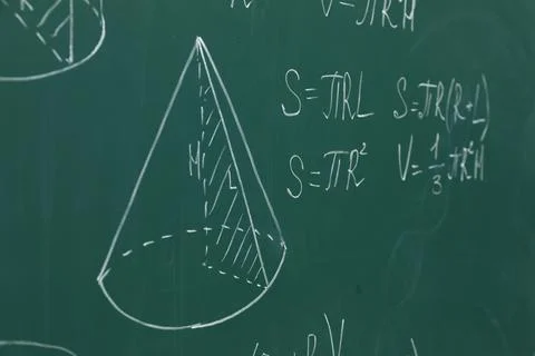 Different math formulas written with chalk on green board Stock Photos
