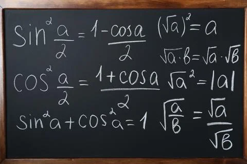 Different mathematical formulas written with chalk on blackboard Fotos de archivo