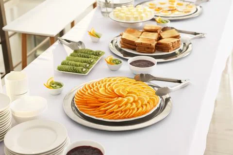 Different meals for breakfast on white table indoors. Buffet service Stock Photos