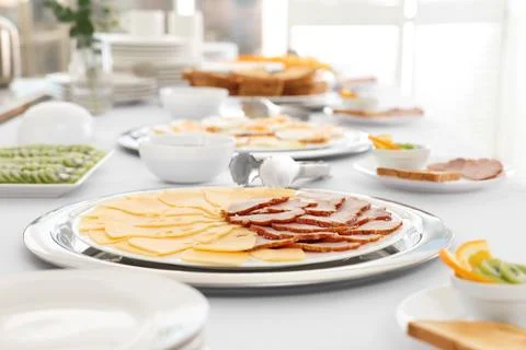 Different meals for breakfast on white table indoors. Buffet service Stock Photos
