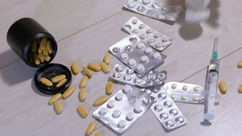 Different medicinal tablets on the floor. Suicide Stock Footage 111522310