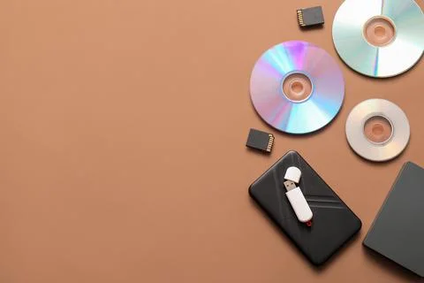 Different memory storage devices on brown background Stock Photos