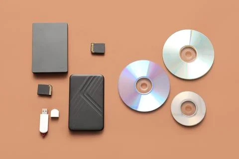 Different memory storage devices on brown background Stock Photos