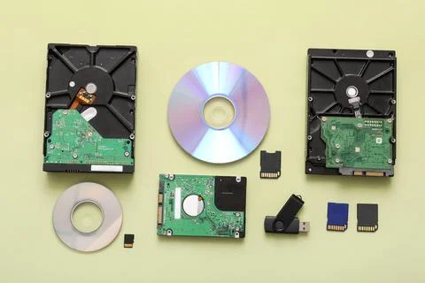 Different memory storage devices on green background Stock Photos