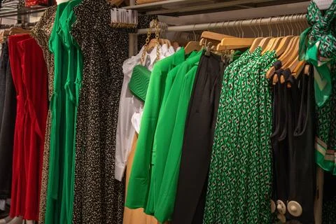 Different models green and red blouses in the store grouped in the color Stock Photos
