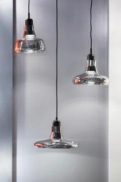 Different modern streamlined mirror silver chandeliers. Bubble metal shade pe Stock Photos