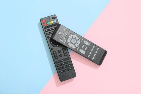 Different modern TV remote controls on color background Stock Photos