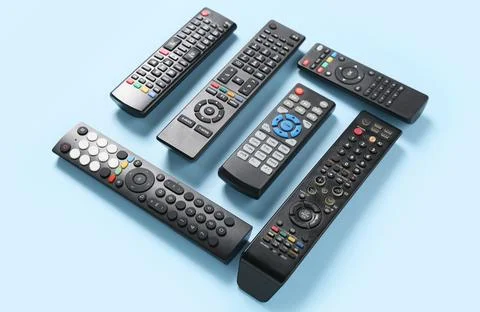Different modern TV remote controls on blue background Stock Photos