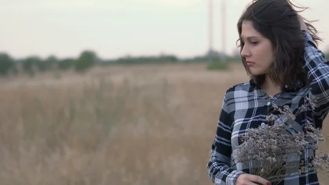 A different mood from the girl.Field, wind Video stock 116246230