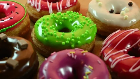 Different multi colored donuts spin Stock Footage 119371105