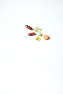 Different multicolored pills, tablets, vitamins, capsules isolated on white.. Stock Photos
