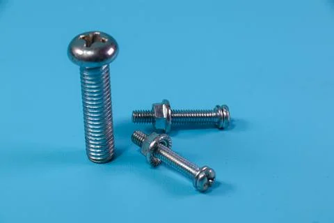 Different nut and bolt on blue background Stock Photos